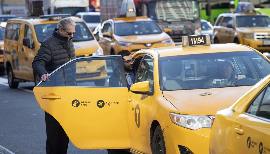 Passengers get into a New York City taxi in 2020. (AP)