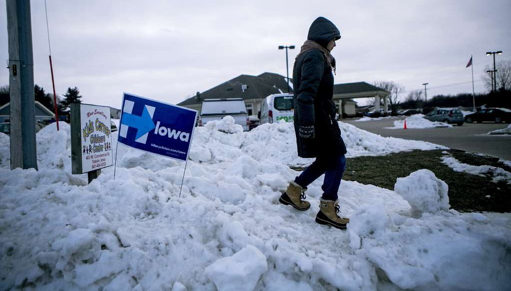 Mara Baron, an organizer for Hillary Clinton, waits out in the snow to direct cars to parking areas for an event where the Democratic presidential hopeful was speaking, in Toledo, Iowa, Jan. 18, 2016. (NYT)