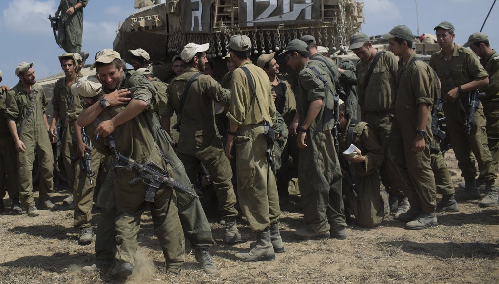 Israeli soldiers embrace as they prepare to leave the country's border with Gaza, Aug. 5, 2014. (New York Times)