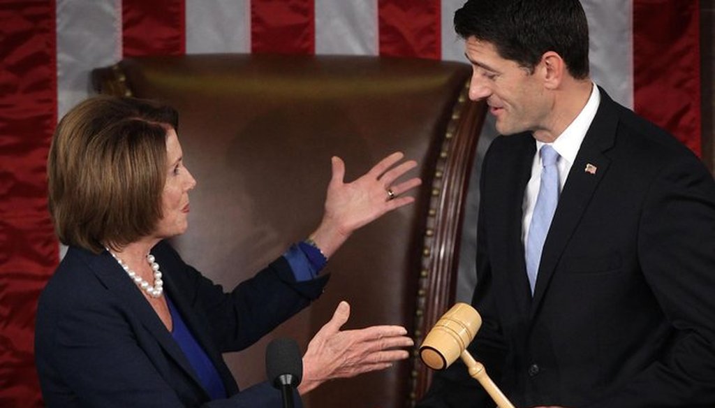 U.S. House Minority Leader Rep. Nancy Pelosi hands a gavel to incoming Speaker Paul Ryan on Oct. 29, 2015, shortly before he was sworn in. (Getty Images)