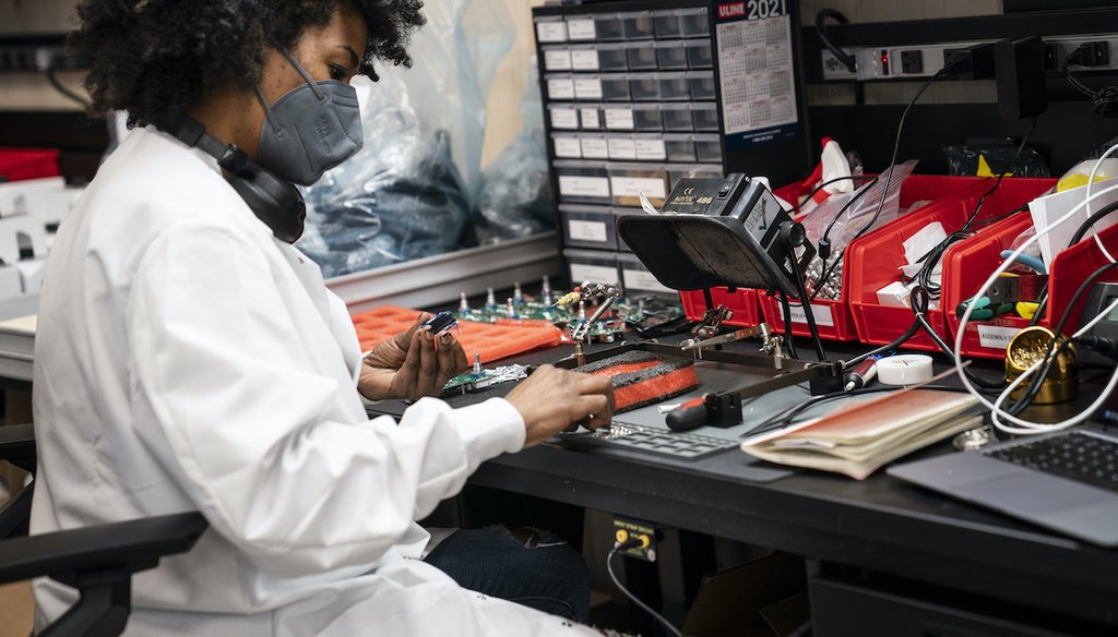 An employee assembles a circuit-board element at a Nanotronics manufacturing center in Brooklyn, New York. (AP Photo/John Minchillo)