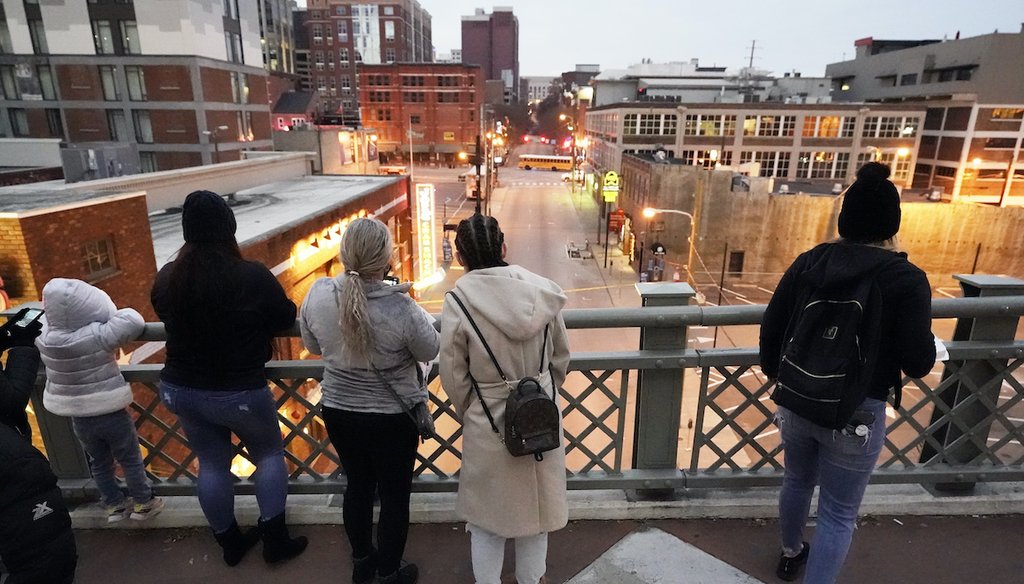 People look from a pedestrian bridge, Monday, Dec. 28, 2020, to view the area several blocks away where an explosion took place Christmas Day in Nashville, Tenn. (AP)