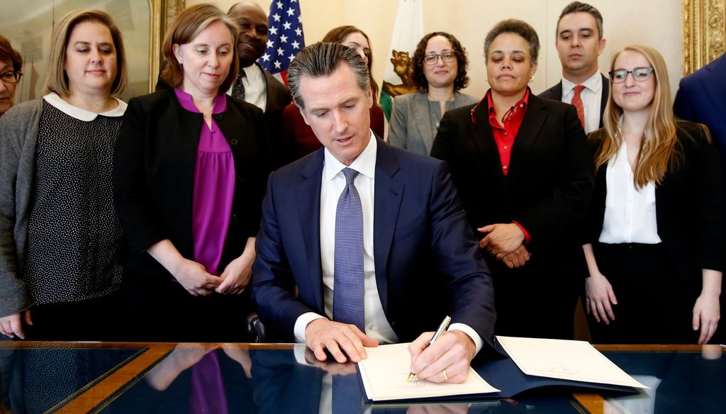 Gov. Gavin Newsom signs the executive order placing a moratorium on the death penalty at his Capitol office Wednesday, March 13, 2019, in Sacramento, Calif. Rich Pedroncelli / AP Photo
