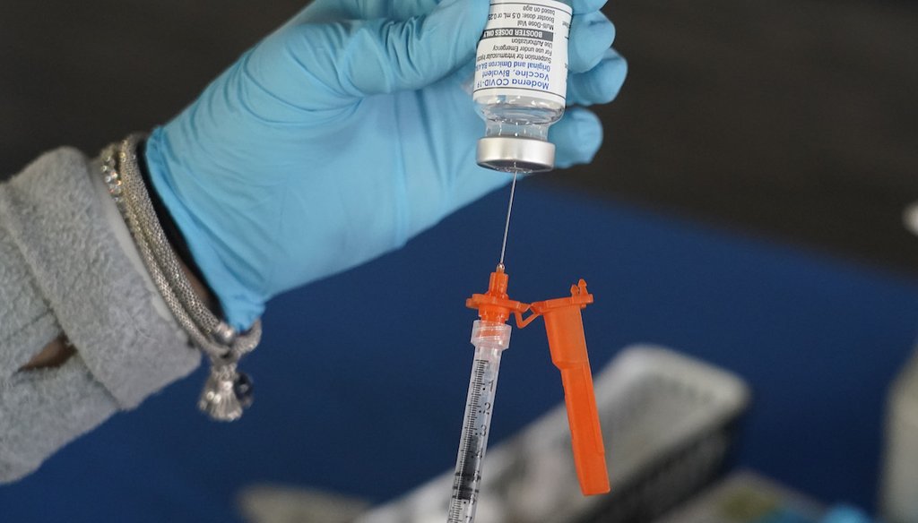 A Jackson-Hinds Comprehensive Health Center nurse loads a syringe with a Moderna COVID-19 booster vaccine at an inoculation station next to Jackson State University in Jackson, Miss., Nov. 18, 2022. (AP)