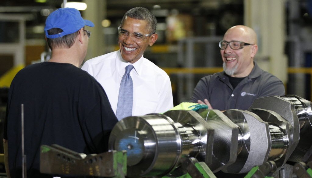 President Barack Obama spoke with employees Calvin Anderson (blue hat) and Ted Korber at a GE gas engines plant in Waukesha, Wis., on Jan. 30, 2014.