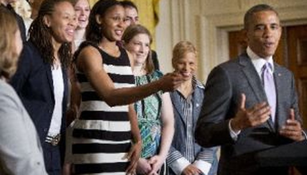 Minnesota Lynx basketball player Maya Moore, center, playfully reaches out to President Barack Obama during a ceremony at the White House on June 12, 2014.