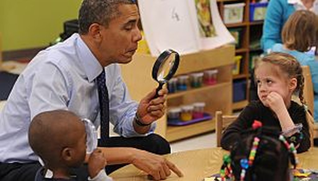 President Barack Obama looks through a spy glass as a little girl stares at him inside a pre-kindergarten classroom in Decatur in February. Obama proposed a nationwide initiative to get more children into pre-K. JOHNNY CRAWFORD /AJC