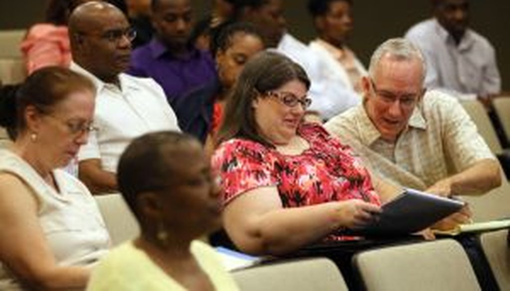 Audience members take notes on health insurance marketplace exchanges in Atlanta July 13th, 2013. The event explained what the Affordable Care Act and the roll out of the online health insurance exchanges mean for consumers. (AJC Photo/Phil Skinner)