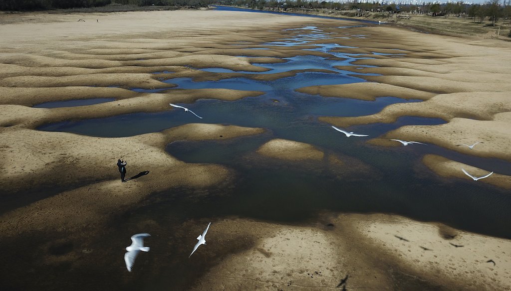 A file photo from July 29, 2021 shows the exposed riverbed of the Old Parana River, a tributary of the Parana River during a drought in Rosario, Argentina. Parana River Basin and its related aquifers provide potable water to close to 40 million people. (A