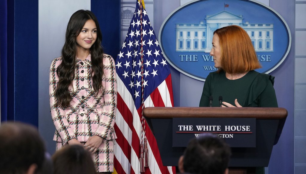 White House press secretary Jen Psaki looks at teen pop star Olivia Rodrigo during the daily briefing at the White House in Washington, Wednesday, July 14, 2021. Rodrigo is at the White House to film a video to promote vaccines. (AP)