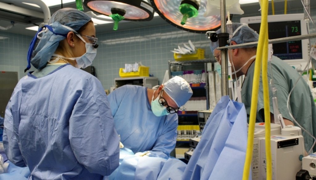 Dr. Murray Shames, center, a vascular surgeon, implants a medical device into a patient at Tampa General Hospital. (Tampa General Hospital)