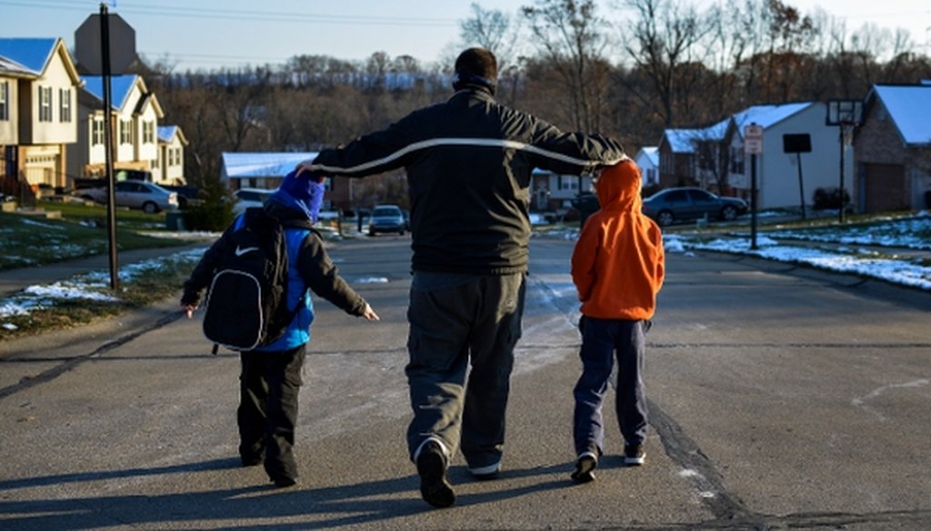 Alex Vories, who lost his job and has since run out of unemployment benefits, with his sons, Caleb, 9, right, and Josh, 6, in Alexandria, Ky., on Nov. 20, 2014. (New York Times)
