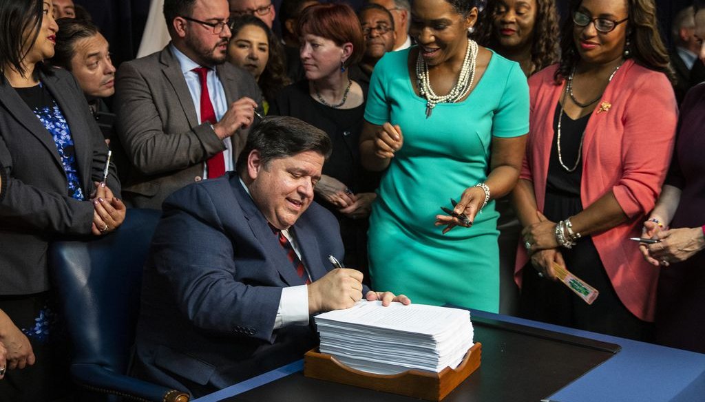 Flanked by supporters, Gov. J.B. Pritzker signs revenue and budget bills during a press conference in Chicago on June 5, 2019. (Ashlee Rezin/Sun-Times)