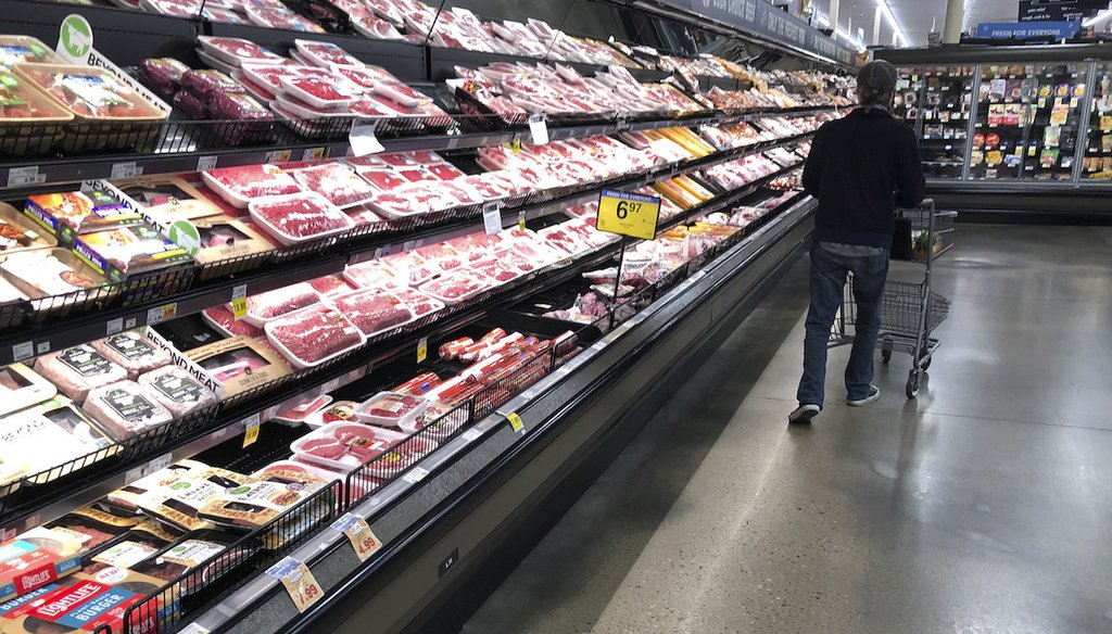 In this May 10, 2020 file photo, a shopper pushes his cart past a display of packaged meat in a grocery store in southeast Denver. (AP)