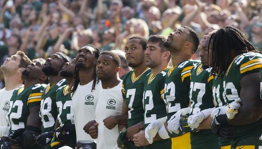 Green Bay Packers players locked arms during the national anthem prior to the team's game on Sept. 24, 2017 at Lambeau Field in Green Bay, Wis. (Mark Hoffman/Milwaukee Journal Sentinel)