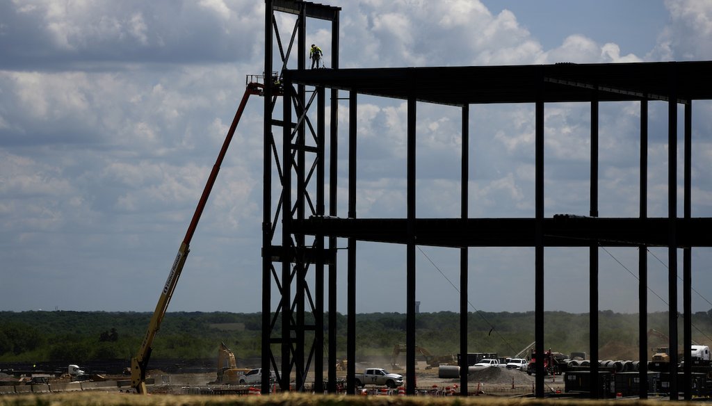 Iron workers construct the framework of a $4 billion Panasonic electric vehicle battery plant on May 18, 2023, near DeSoto, Kan. (AP)