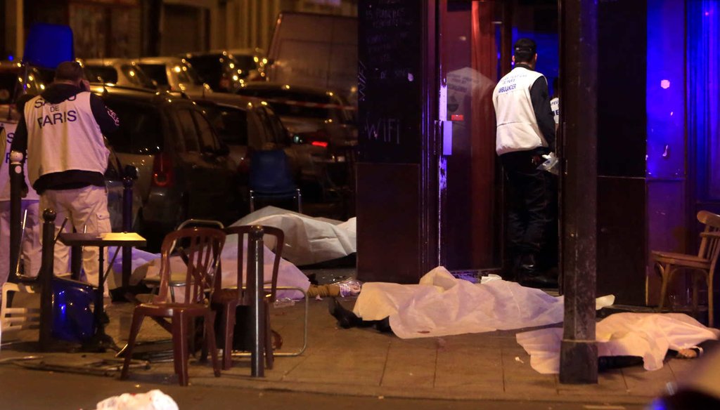 Victims's bodies lie on the sidewalk outside a Paris restaurant following a wave of attacks Friday. (AP)