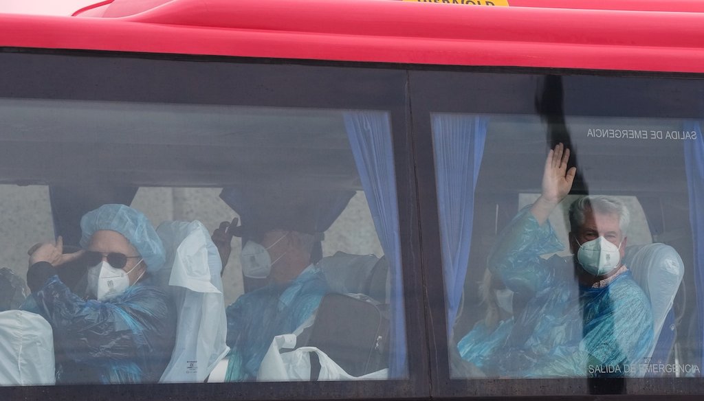 Passengers wave inside a bus after being disembarked from the hantavirus-stricken cruise ship MV Hondius at the port of Granadilla in Tenerife, Canary Islands, Spain, May 10, 2026. (AP)