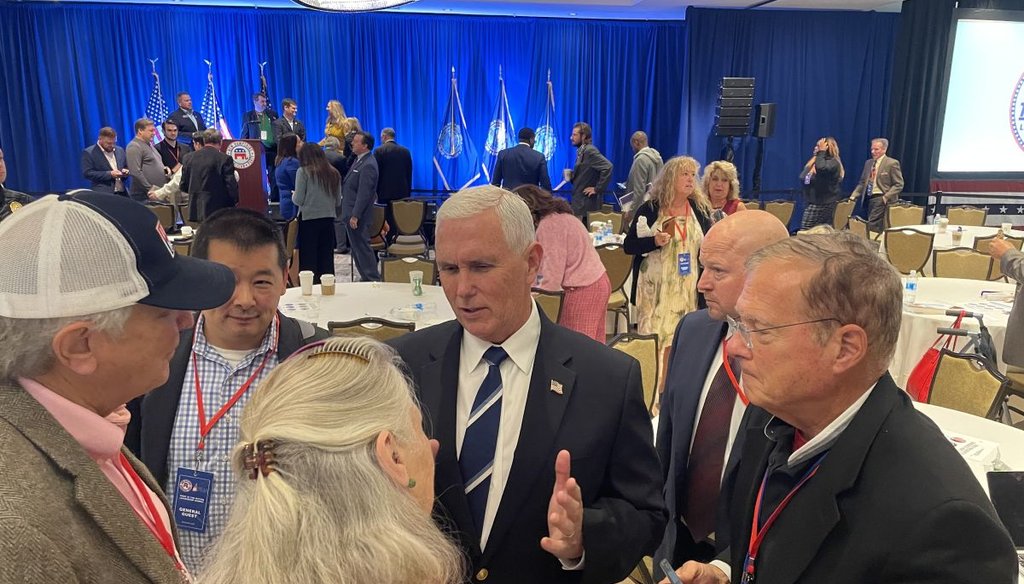 Former Vice President Mike Pence, a Republican presidential candidate, talks with attendees Oct. 14, 2023, at the First in the Nation summit in Nashua, N.H. (Louis Jacobson/PolitiFact)