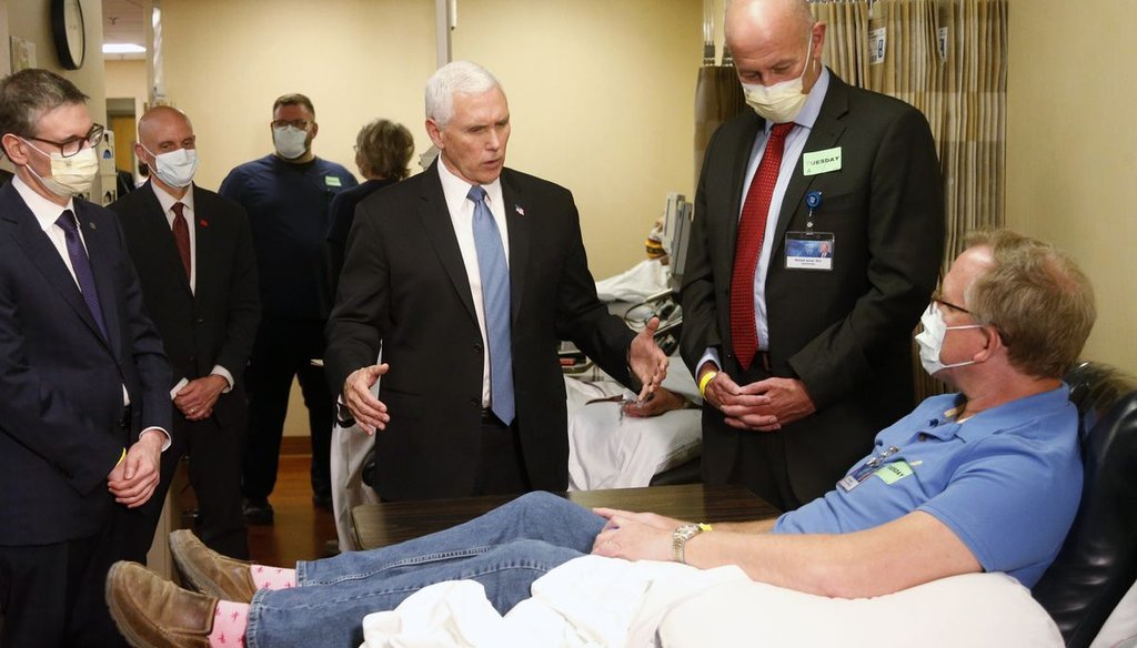 Vice President Mike Pence, center, visits Dennis Nelson, a patient who survived the coronavirus and was going to give blood, during a tour of the Mayo Clinic in Rochester, Minn., on April 28, 2020. Pence chose not to wear a face mask. (AP)