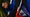 People hold hands and a Haitian flag during a vigil amid the legal battle to end TPS for Haitians in February 2026 at the Little Haiti Cultural Complex in Miami. (AP)