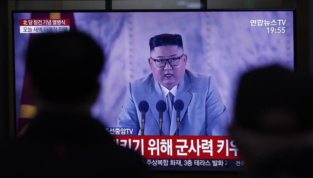 People in Seoul, South Korea, watch a TV screen showing a news report about an Oct. 10, 2020, ceremony to mark the 75th founding anniversary of the North Korea's ruling Workers' party. A part of letters read "Military strength." (AP)