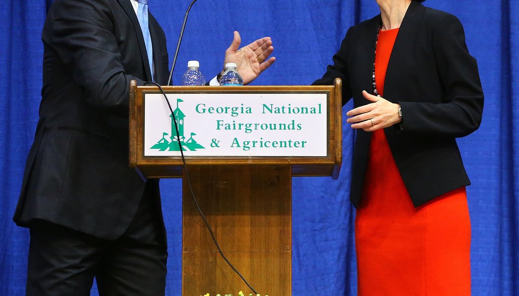 U.S. Senate hopefuls David Perdue and Michelle Nunn shake hands at the conclusion of their debate Oct. 7 at the Georgia National Fair in Perry. CURTIS COMPTON / CCOMPTON@AJC.COM