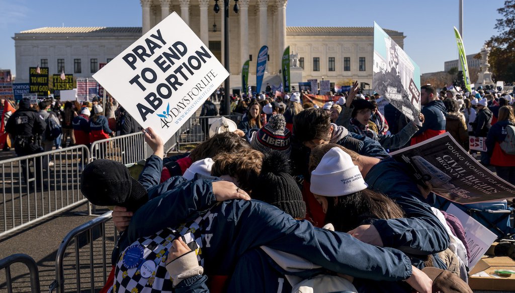 A group of anti-abortion protesters pray together in front of the U.S. Supreme Court as the court hears arguments in a case from Mississippi, where a 2018 law would ban abortions after 15 weeks of pregnancy, well before viability. (AP)