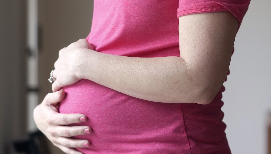 A pregnant woman stands for a portrait in Dallas, May 18, 2023. (AP)