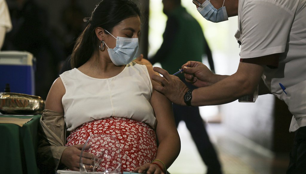 A pregnant woman gets a Pfizer vaccine shot for COVID-19 at a library converted into a vaccination center in Mexico City, Thursday, May 13, 2021. The vaccine has been found to be safe and effective in pregnancy. (AP)