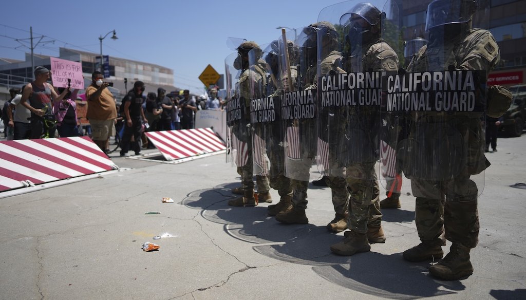 Protesters confront a line of U.S. National Guard in the metropolitan detention center of downtown Los Angeles, June 8, 2025, following last night's immigration raid protest. (AP)