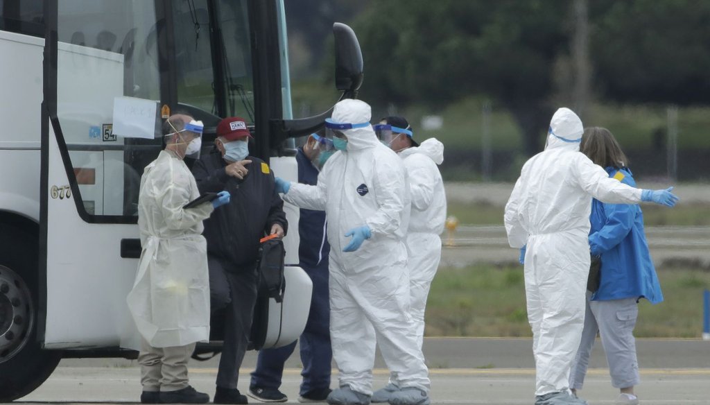 Passengers from the Grand Princess, a cruise ship carrying multiple people who have tested positive for COVID-19, exit a bus before boarding a chartered plane in Oakland, Calif., on March 10, 2020. (AP)