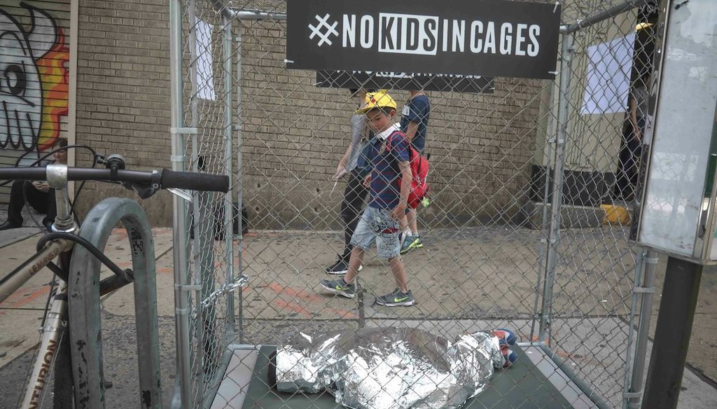 Riders leaving a subway station in Brooklyn, N.Y., pass by a pop-up art installation on June 12, 2019. The project featured mannequins as part of the #NOKIDSINCAGES campaign to support Refugee and Immigrant Center for Education and Legal Services. (AP)