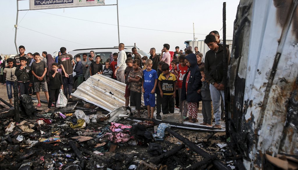 Palestinians look at the destruction after an Israeli strike where displaced people were staying in Rafah, Gaza Strip, May 27, 2024. (AP)