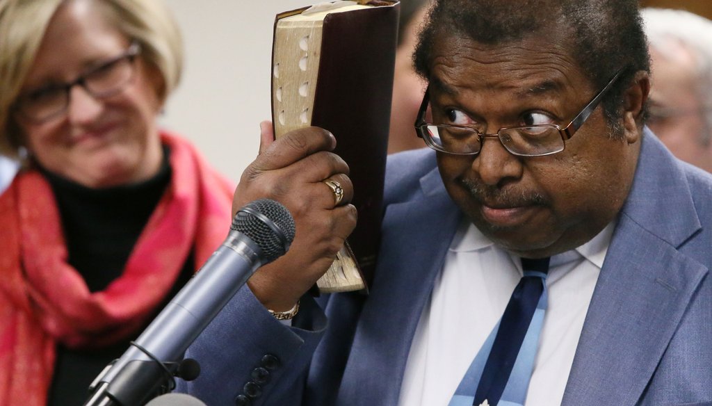 The Rev. Timothy McDonald III of First Iconium Baptist Church holds his Bible as he explains his opposition to a religious liberty bill pending in the Georgia Legislature. Photo by Bob Andres / AJC.