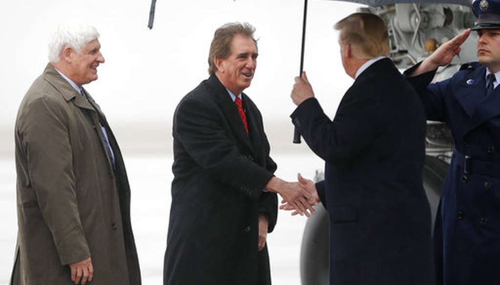President Donald Trump, right, is greeted by Rep. Jim Renacci, R-Ohio, center, and Bryan C. Williams, left, Chairman for the Summit County Republican Party, on his arrival at Cleveland Hopkins International Airport, March 29, 2018, in Cleveland. (AP)