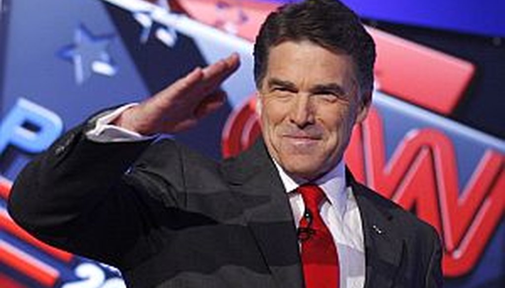 Republican presidential candidates Texas Gov. Rick Perry salutes the crowd before a Republican presidential debate Oct. 18 in Las Vegas.