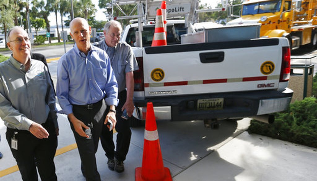 Florida Gov. Rick Scott, center, walks with Florida Department of Transportation (FDOT) workers as he arrives at a news conference at the FDOT District Four Office, Wednesday, Aug. 22, 2018, in Fort Lauderdale, Fla. (AP)