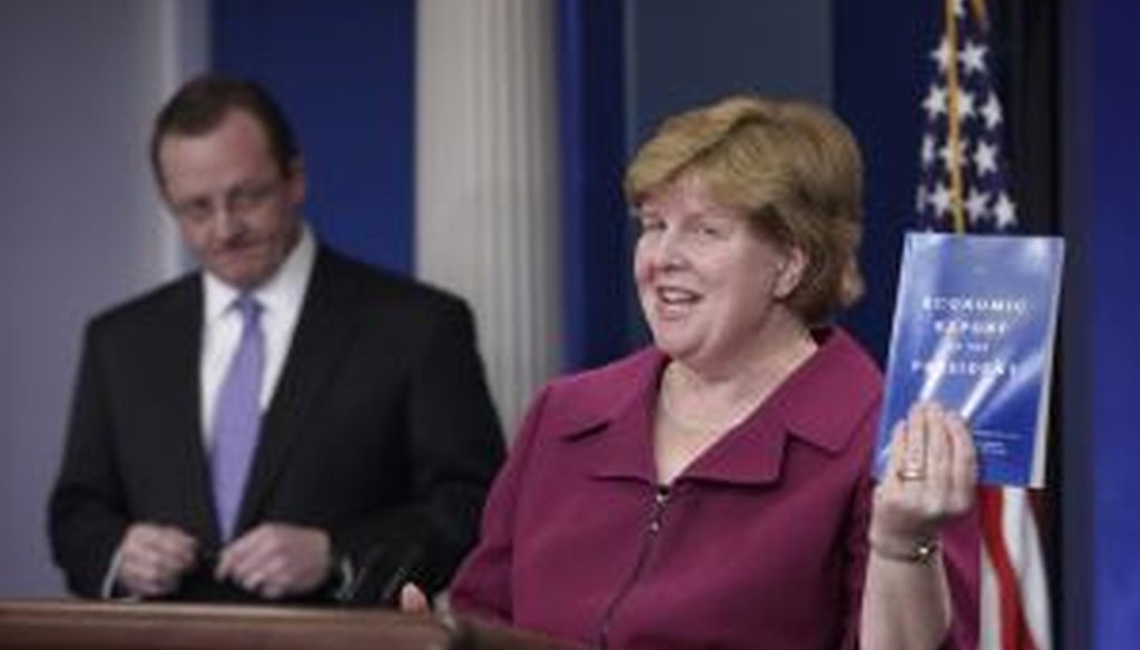 Council of Economic Advisers Chair Christina Romer holds up a copy of the 'Economic Report of the President' for 2010.