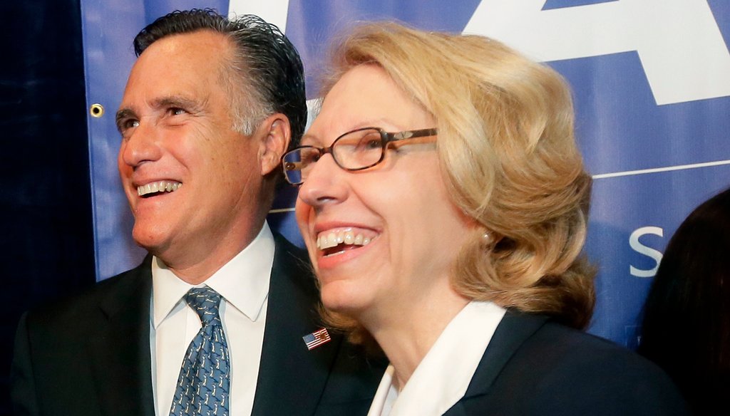2012 Republican presidential candidate Mitt Romney stands with Michigan Senate candidate Terri Lynn Land in Livonia, Mich., Oct. 2, 2014. In 2012, Land said she was "with (Romney)" in his opposition to the strategy for the federal auto bailout.