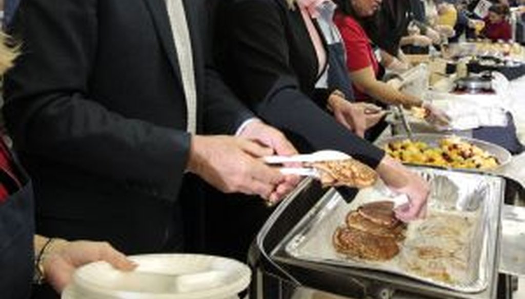 Mitt Romney served up pancakes and talking points at a campaign stop at Brookwood High School in Snellville Sunday March 4