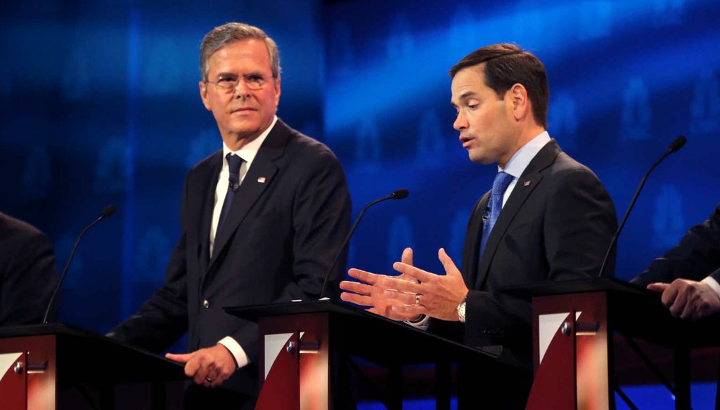 Florida Sen. Marco Rubio answers a question at the third GOP debate as former Florida Gov. Jeb Bush looks on. (NYT)