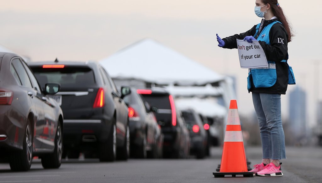 Philadelphia Medical Reserve Corps volunteer Emma Ewing, a sophomore at Temple University, directs cars at the city's coronavirus testing site next to Citizens Bank Park in South Philadelphia on Friday, March 20, 2020. TIM TAI / Inquirer Photographer