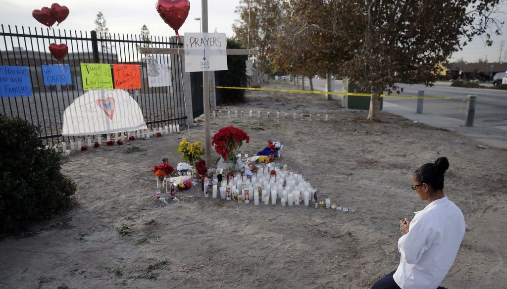 A woman prays at a makeshift memorial on Friday, Dec. 4, 2015, in San Bernardino, Calif., where a husband and wife gunned down 14 people at a holiday office party. (AP)