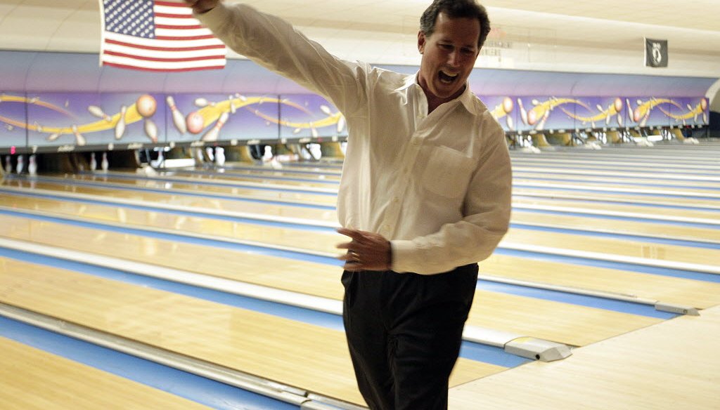 In this Associated Press photo, GOP presidential hopeful Rick Santorum celebrates bowling a strike while campaigning in Wisconsin.