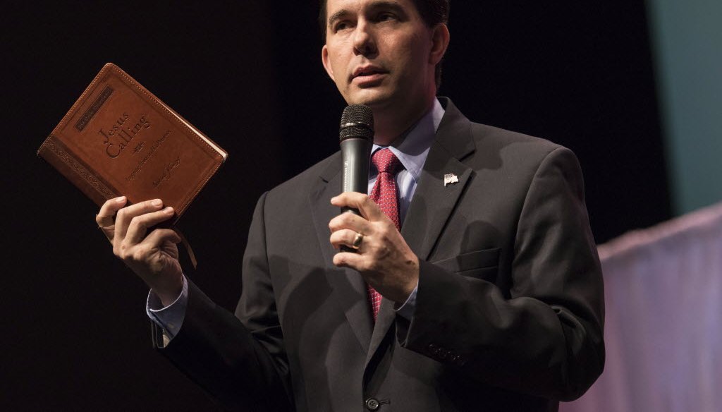 Holding a book called "Jesus Calling," Gov. Scott Walker spoke at the Iowa Faith & Freedom Coalition presidential forum on April 25, 2015. He is scheduled to return to Iowa on May 16, 2015. (AP photo)