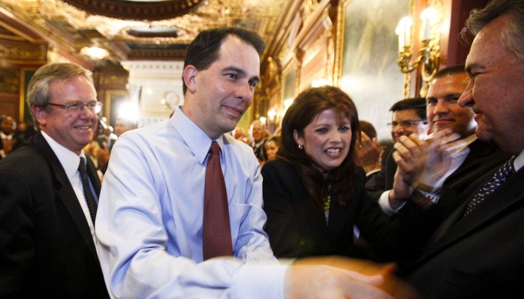 Gov. Scott Walker and Lt. Gov. Rebecca Kleefisch are greeted by the governor's cabinet and staff at the state Capitol on June 6, 2012, a day after they won recall elections. (AP photo)