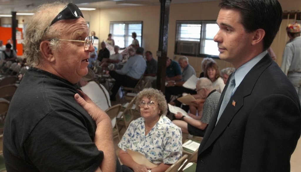 Wisconsin Gov. Scott Walker (right) was the Milwaukee County executive when he chatted with a constituent during a county budget hearing in 2002. (Milwaukee Journal Sentinel)