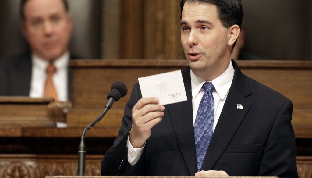 During his 2013 budget address to the Wisconsin Legislature, Gov. Scott Walker read from a card from a resident who thanked him for lower property taxes. (Mark Hoffman/Milwaukee Journal Sentinel)