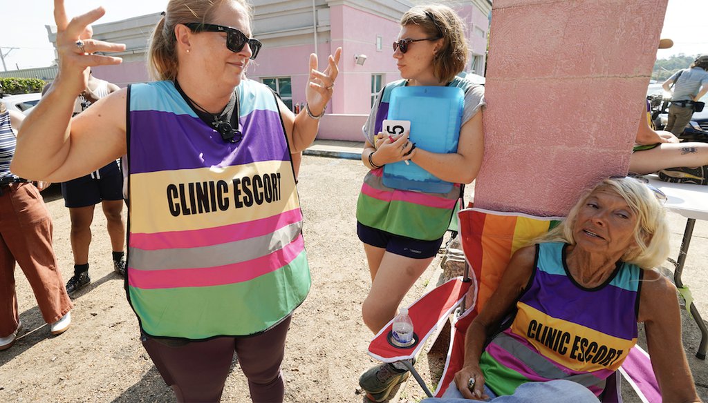Escorts confer as they await patients at an abortion clinic in Jackson, Miss., on June 29, 2022. (AP)